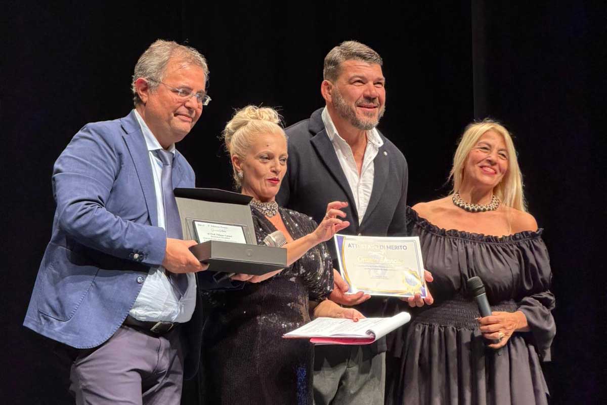 Un momento della consegna del premio al prof. Filippo Caraci. A consegnarlo la presidentessa di Futura21, Anna Papale, e il rugbista Orazio Arancio